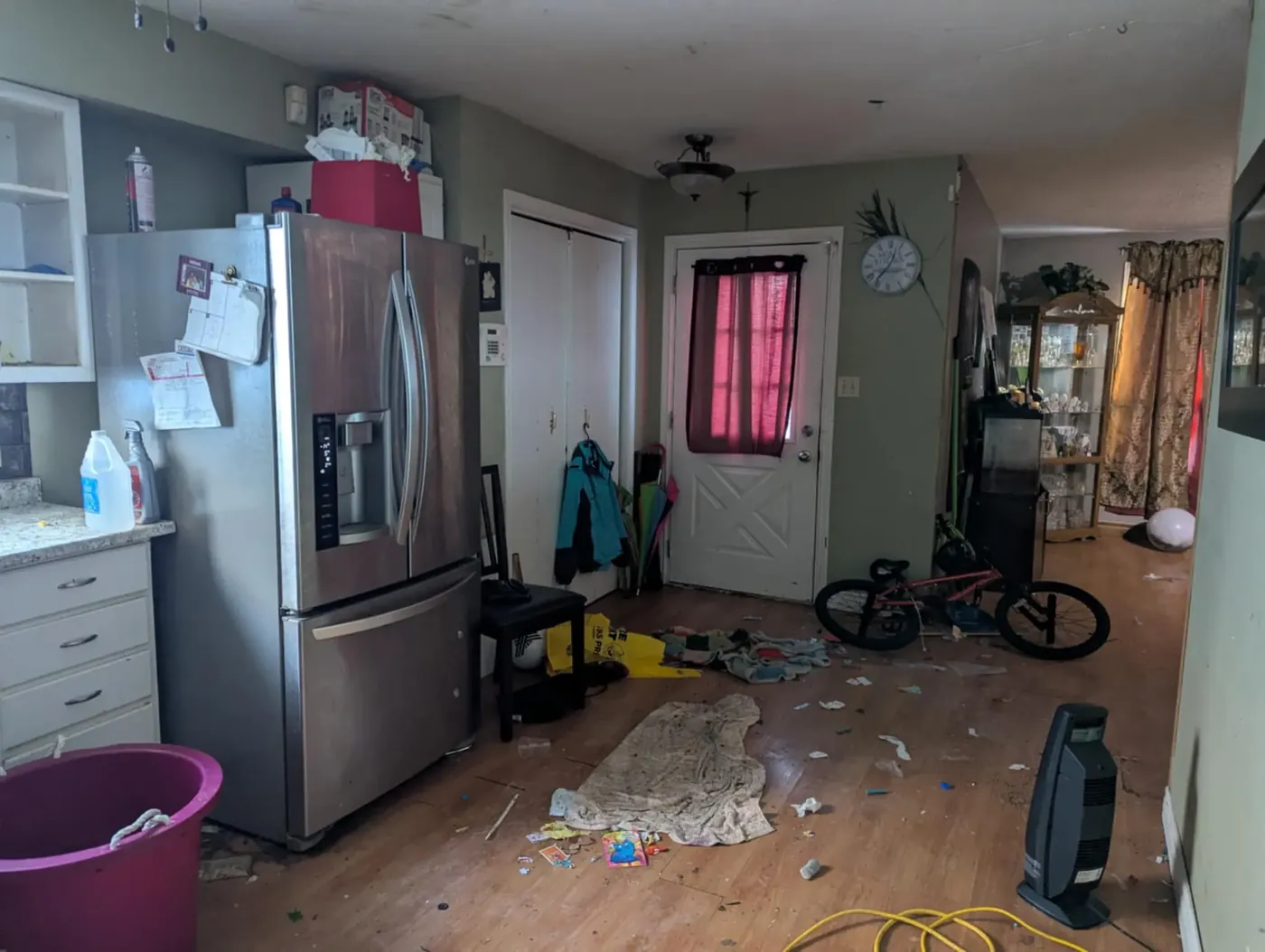 Heavily cluttered kitchen inside an Iowa home, the kind of cleanout Cash For Homes Iowa handles after closing.